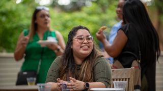 A smiling student sitting at a table