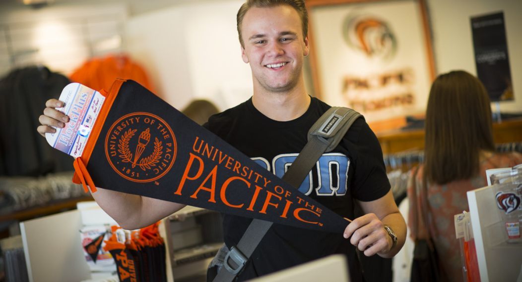 guy holding pennant 