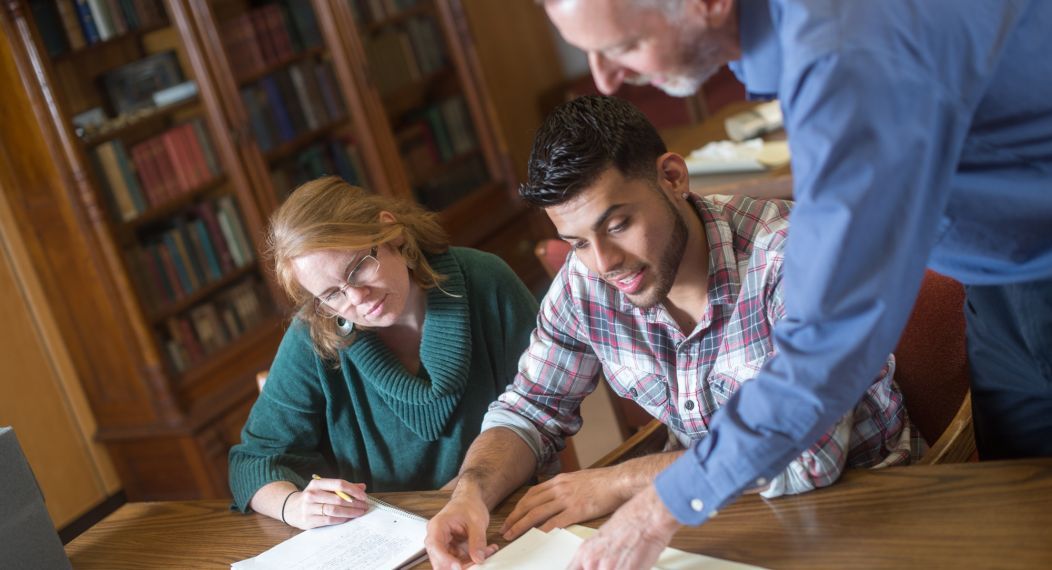 Students view archives with Special Collections staff