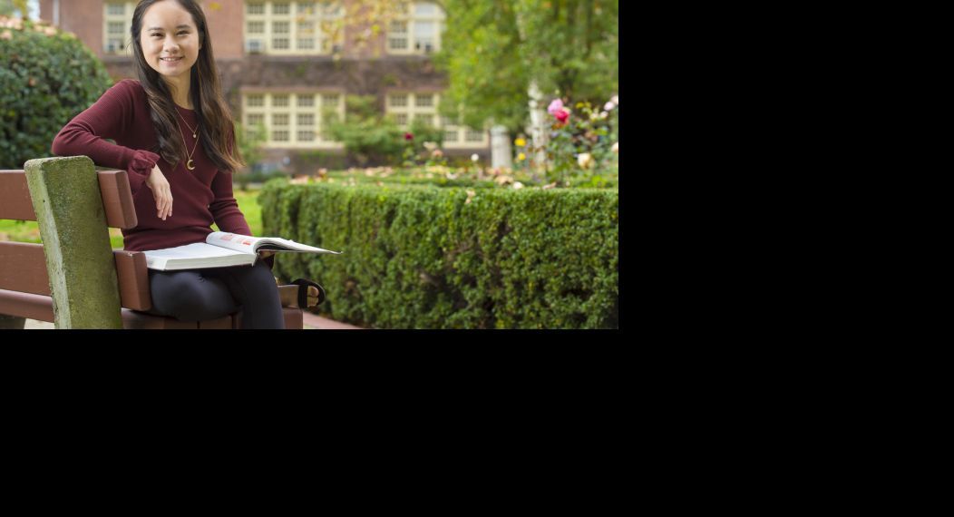 Language student sitting on campus bench