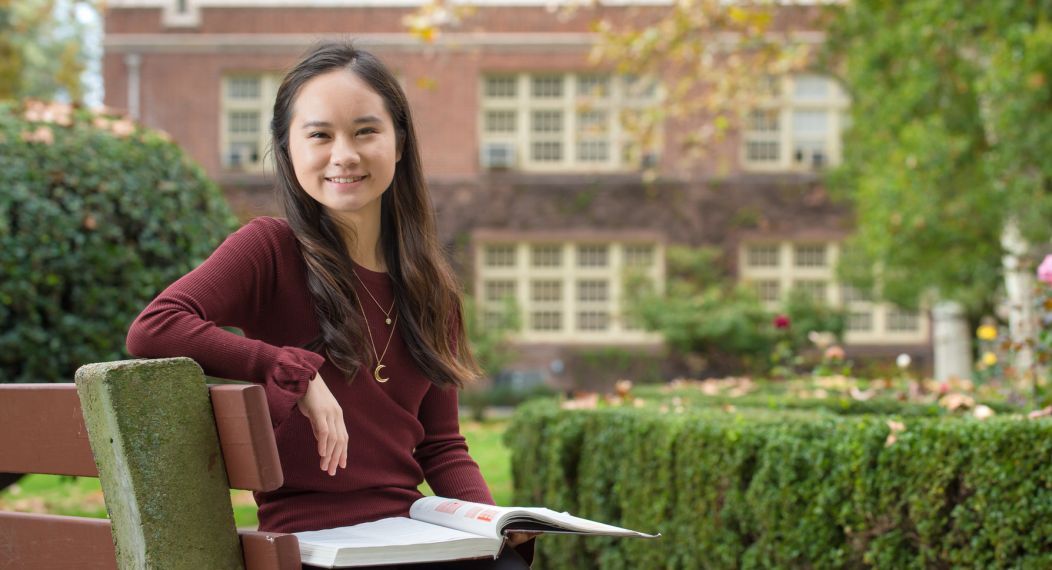 Language student sitting on bench