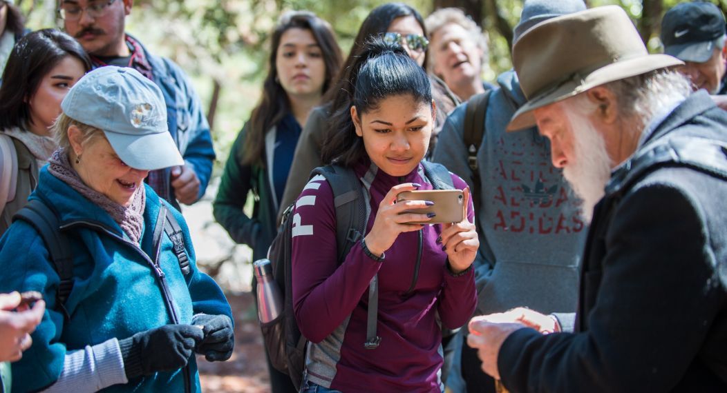 student taking picture of tour guide