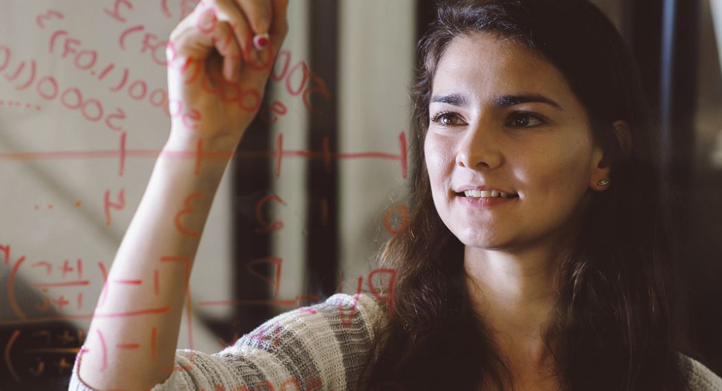 math student writing on glass