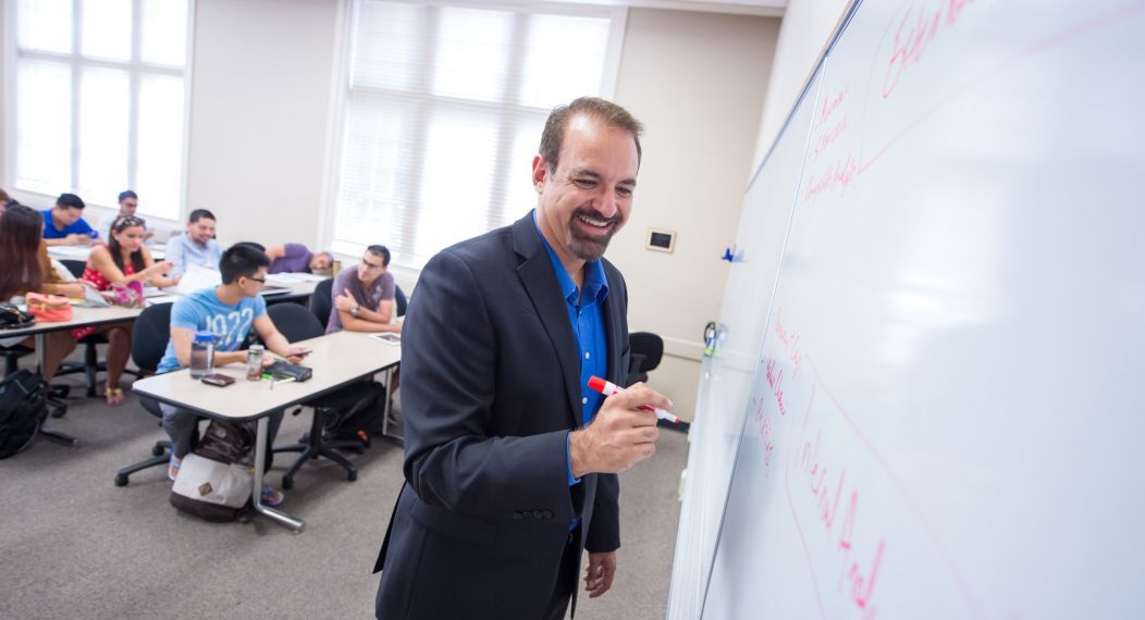 Eberhardt School of Business professor at white board in classroom