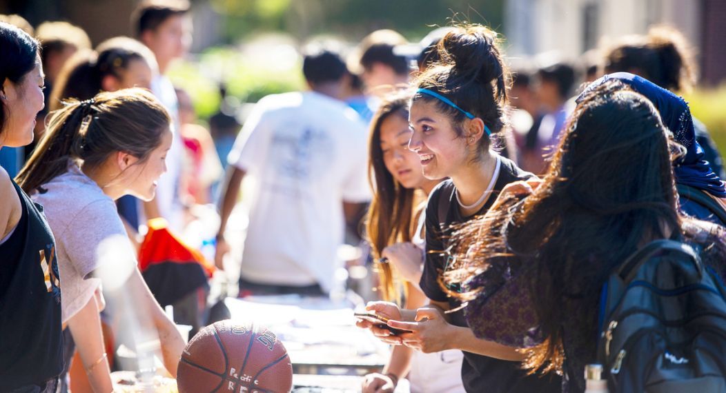 students learn about clubs and organizations at club fair