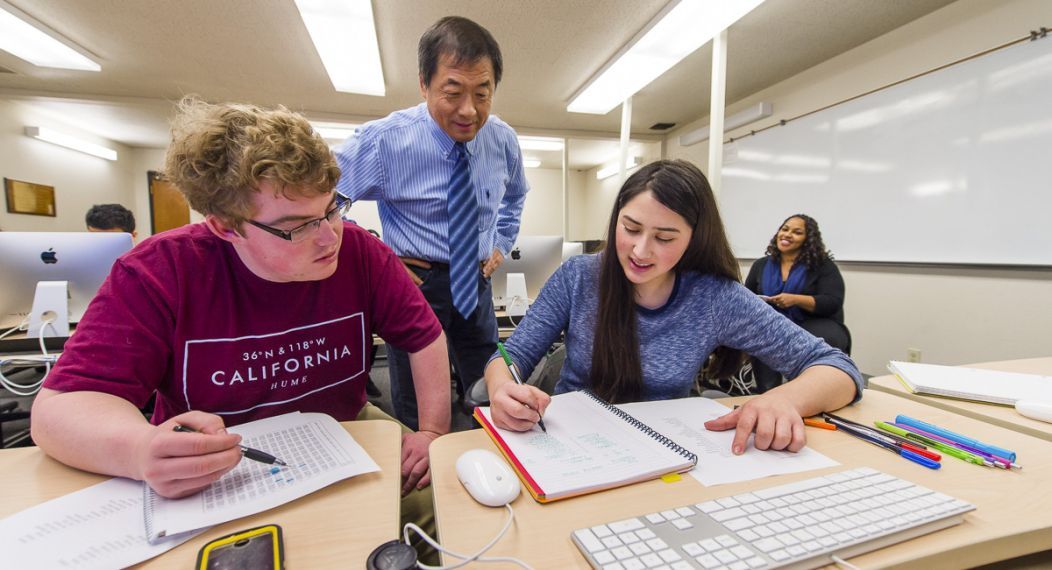 College of the Pacific communications classroom with faculty working with students