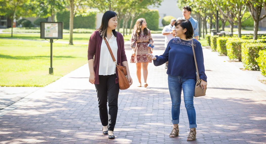 graduate students walk on campus