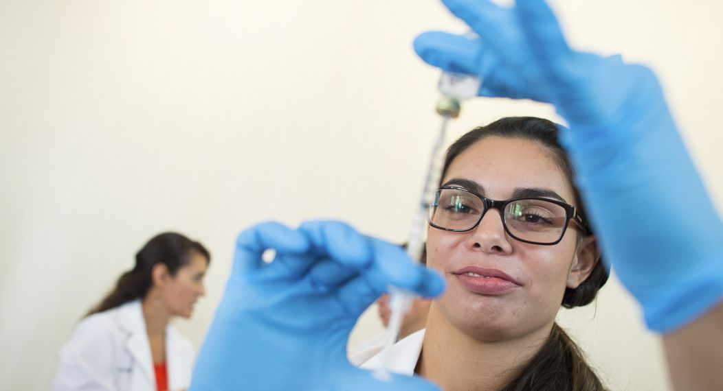 a pharmacy student prepares a flu shot