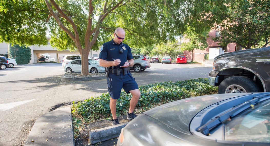 public safety employee checks a parking spot