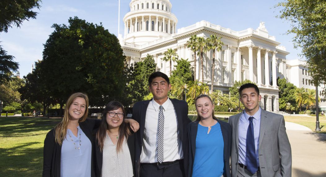 students standing in front of state capitol