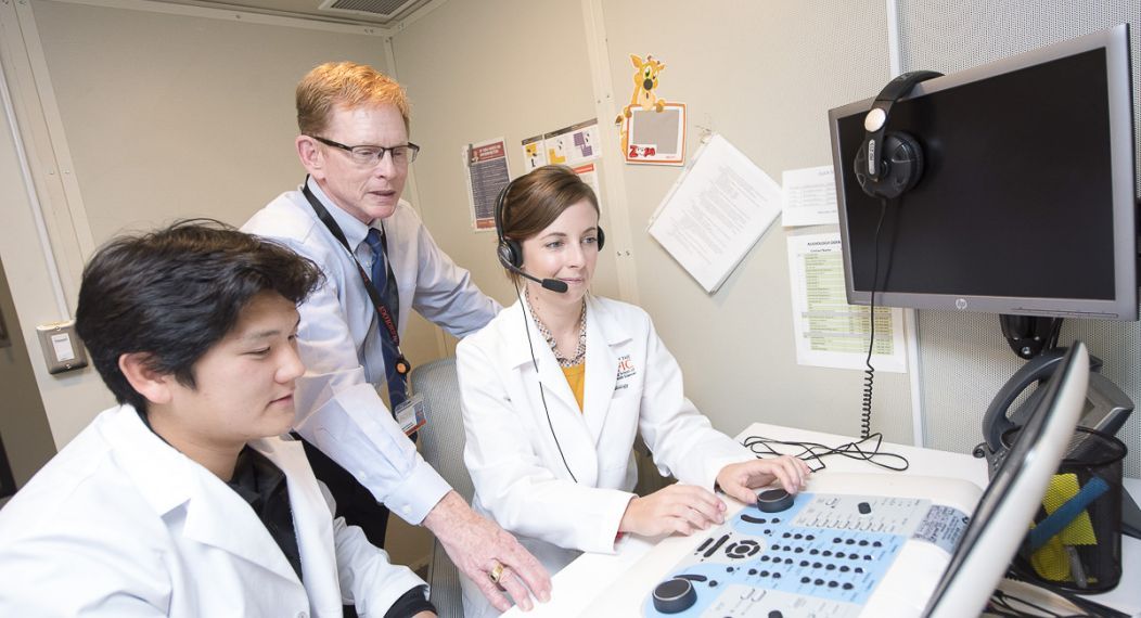 audiology professor and students in lab