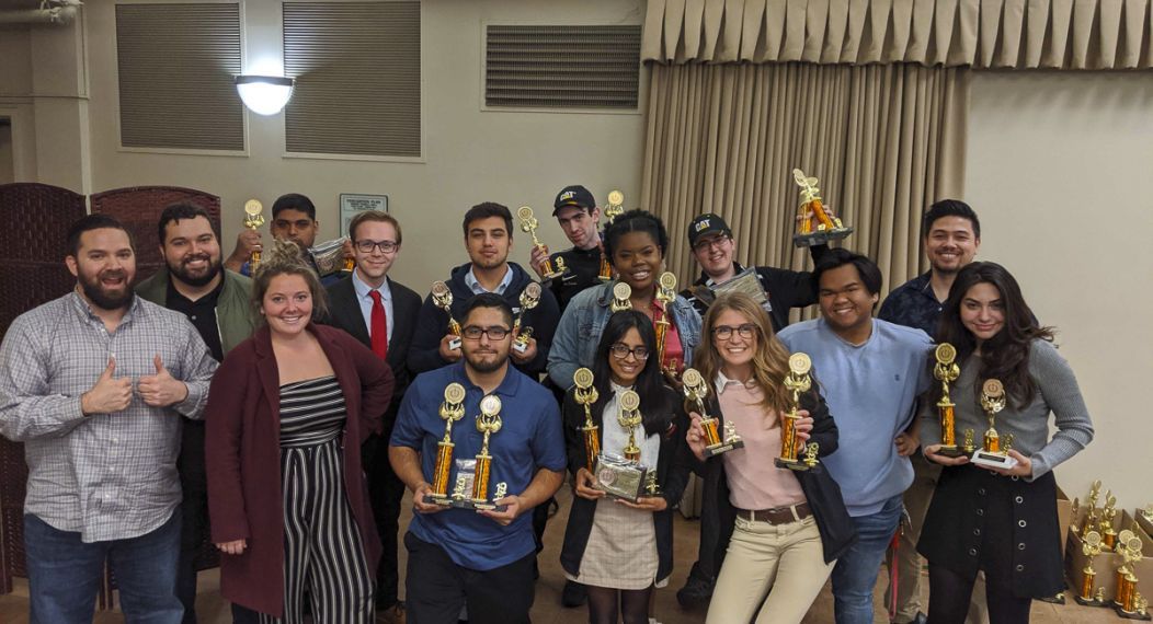 Debate team holding awards