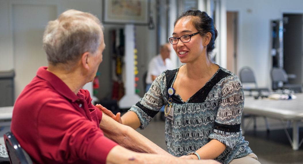 student working with patient in clinic