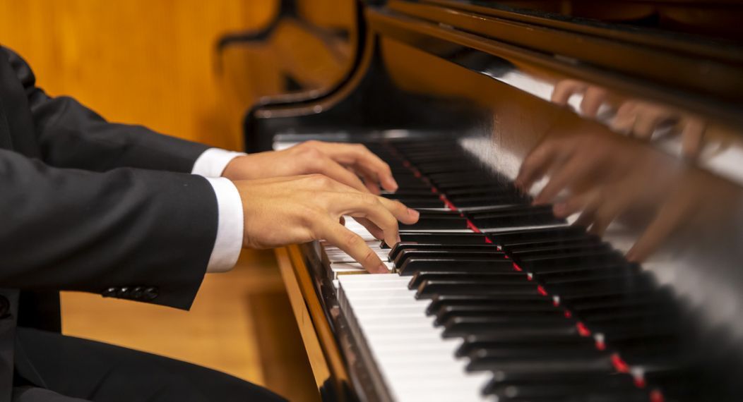 Pianists hands on a keyboard