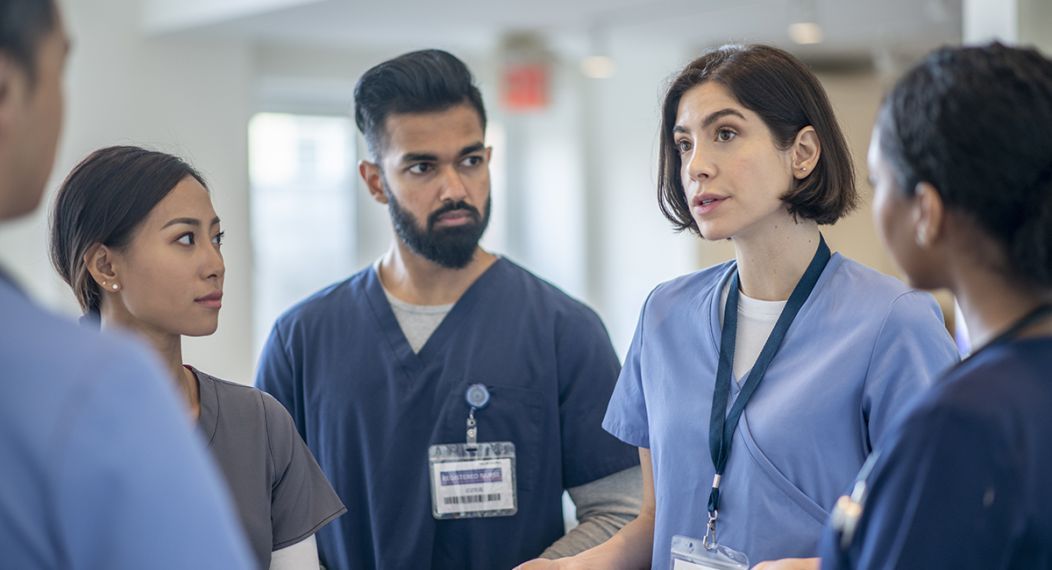 healthcare professionals talking in a group
