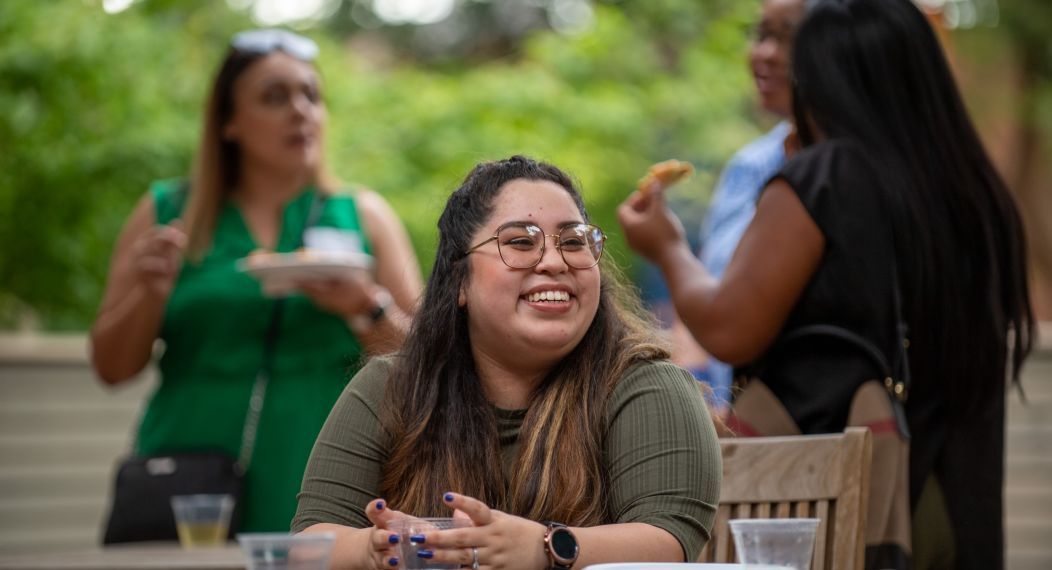 A smiling student sitting at a table