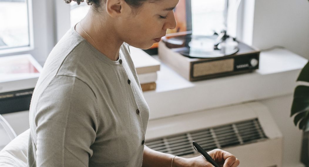 Woman writing on clipboard