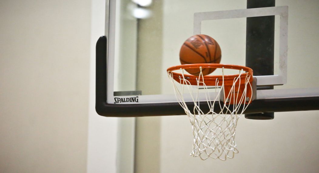 A basketball about to go in the net