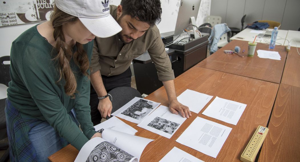 students looking at drafts of papers and essays