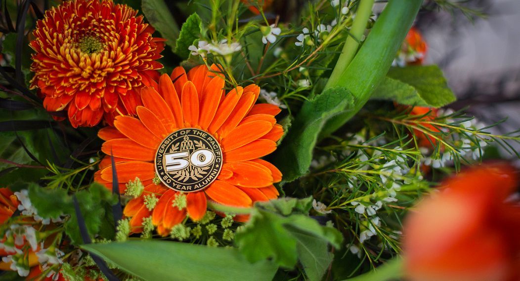 orange flowers and a 50th reunion pin