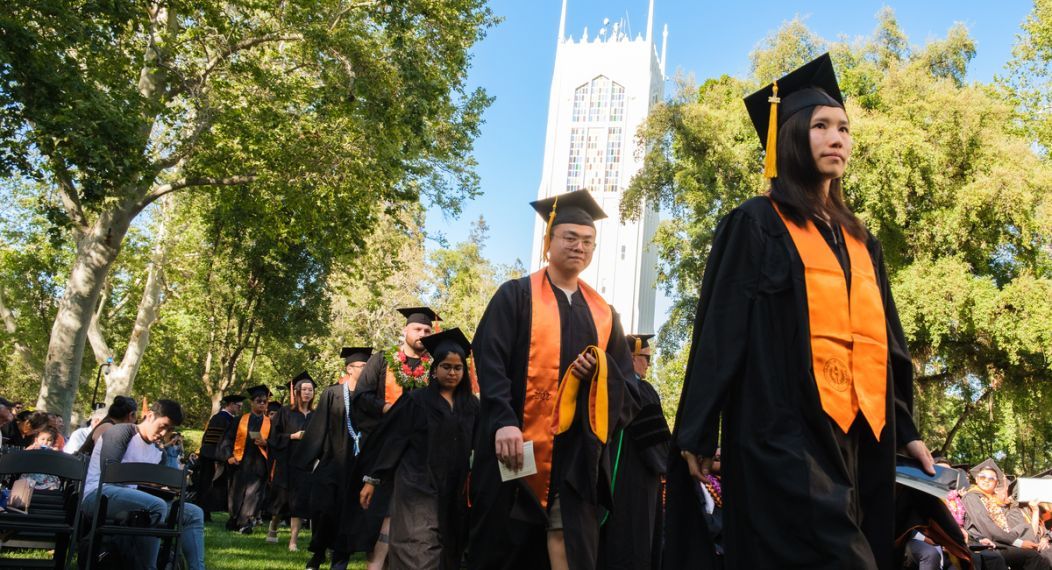 Graduating students walking at commencement