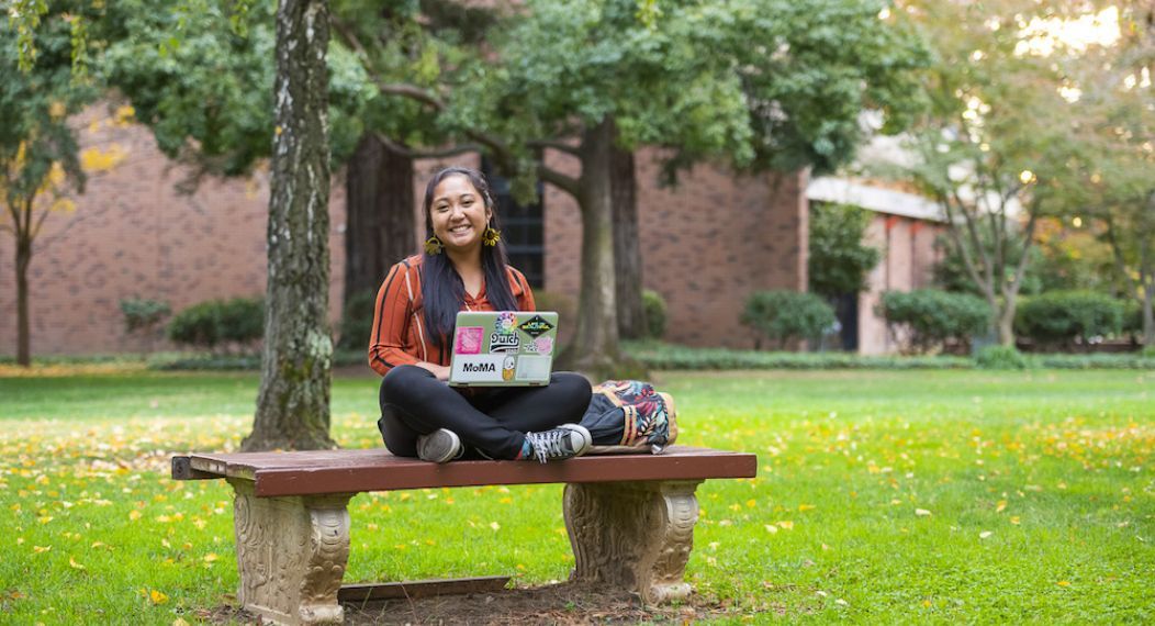 student in middle of campus