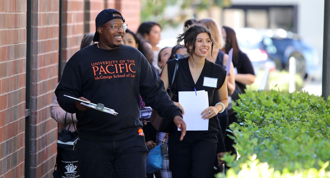 A group of students walk on campus