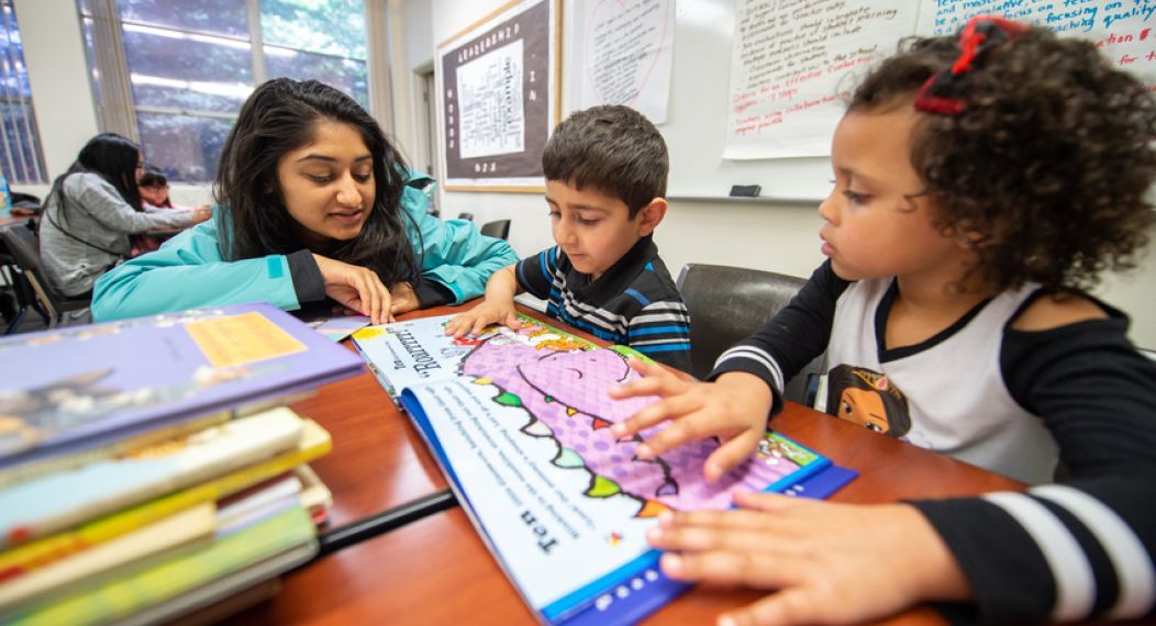 Students reading with mentor