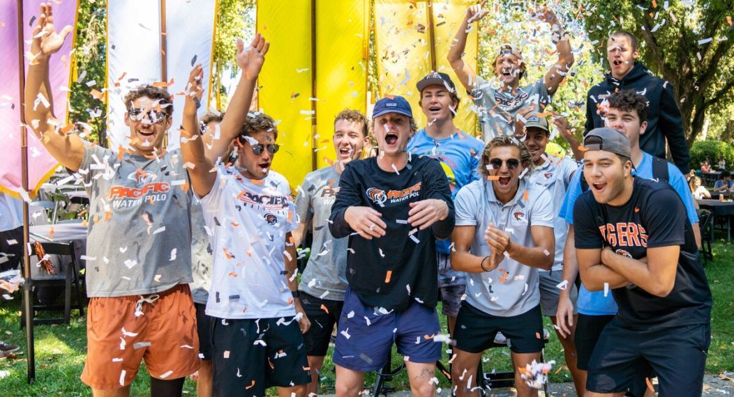 group of male university of the pacific students celebrating