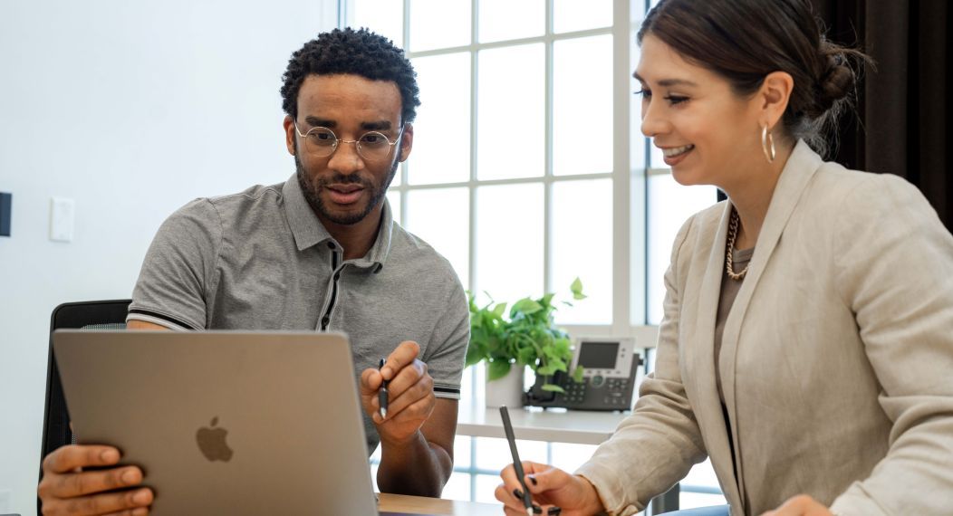 Business Law students collaborating in front of a computer