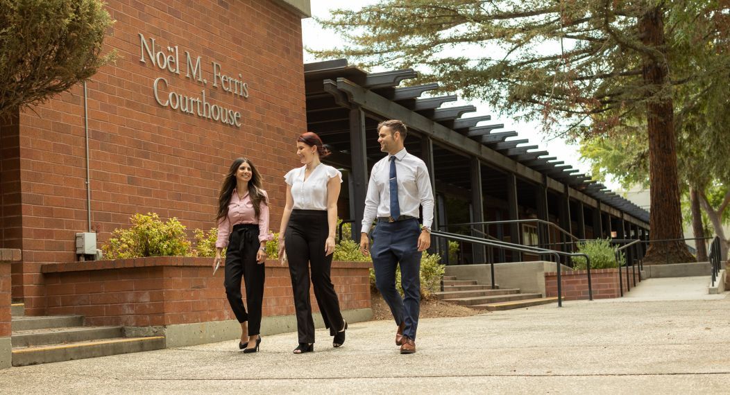 three students walking on campus