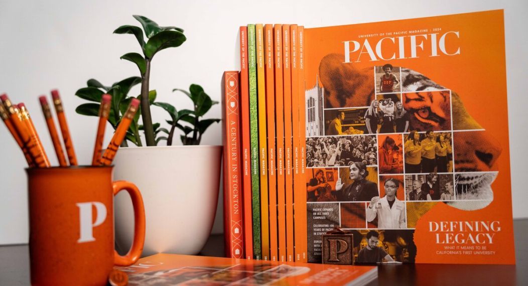 a stack of 2024 Pacific magazines next to a cup filled with pencils