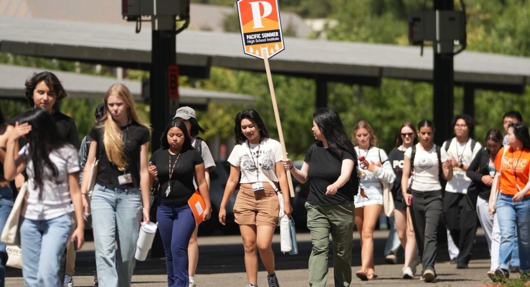 summer high school institute students walk across a parking lot