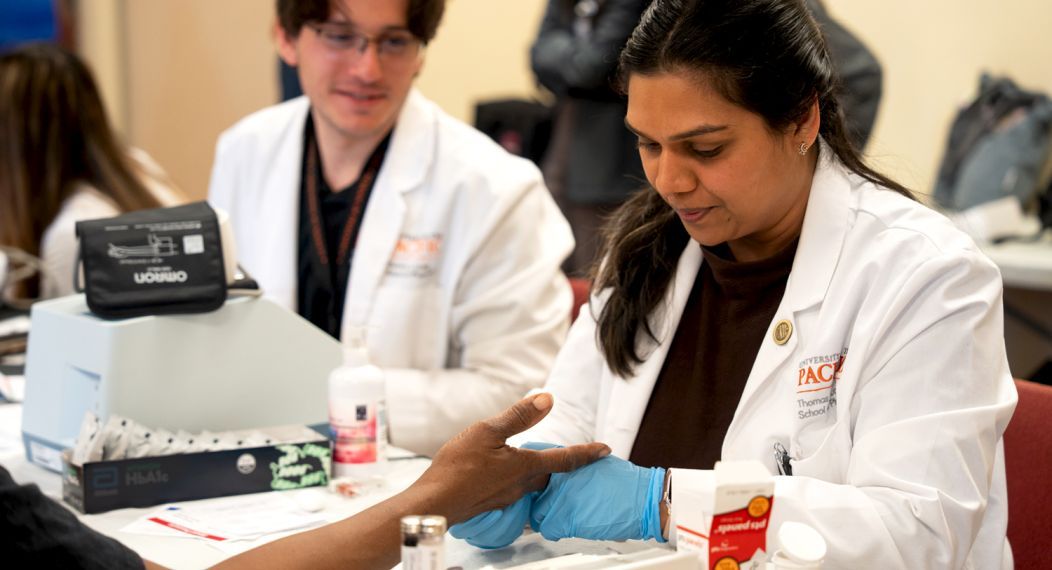 Doctor of pharmacy student with patient at diabetes clinic