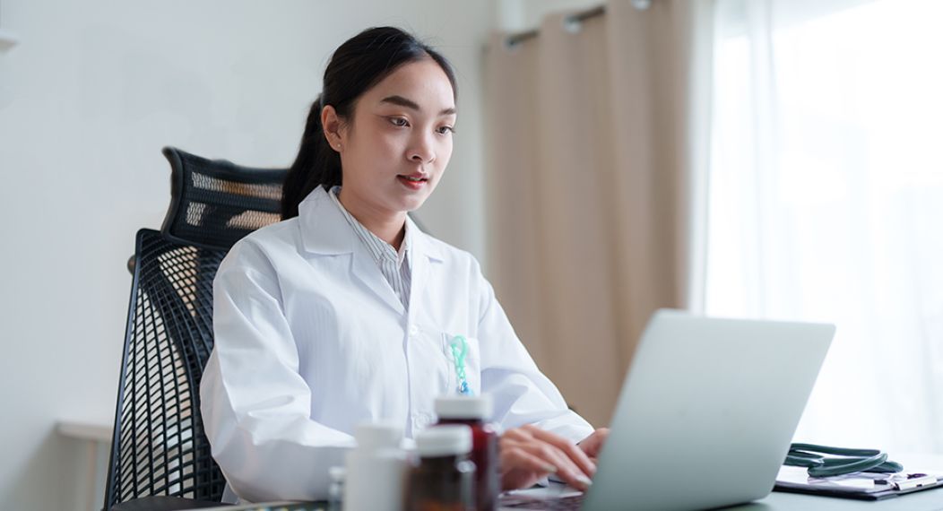 Health professional working on their laptop