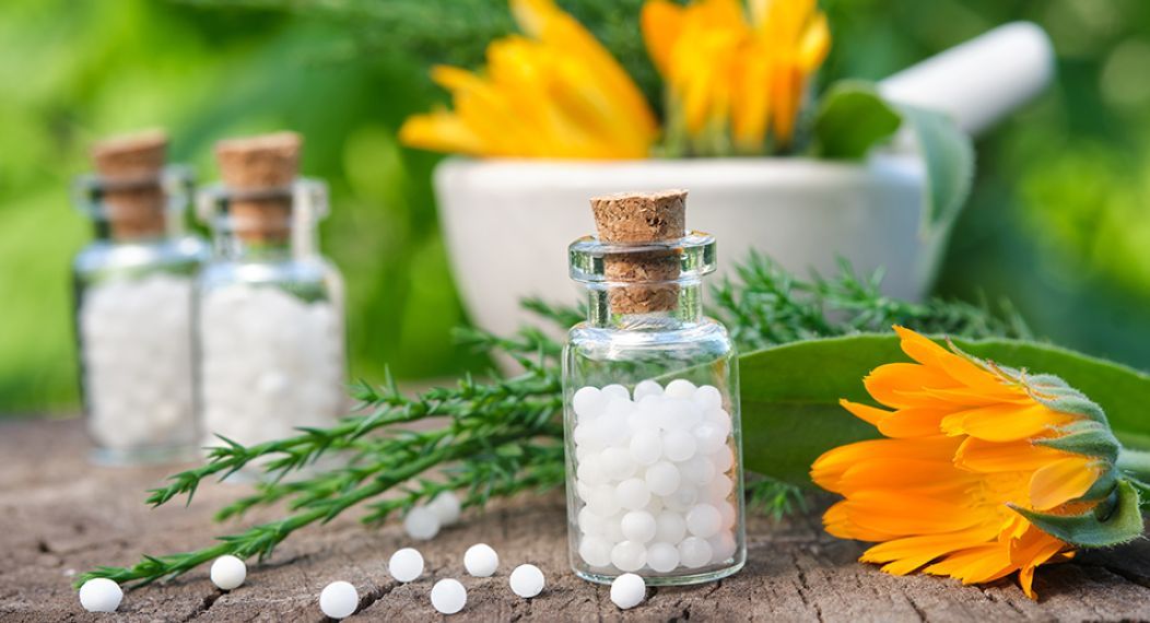 Bottles of arnica montana and a mortar and pestle