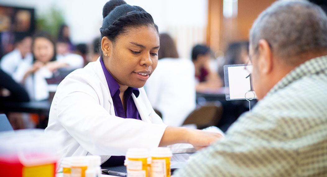 Pharmacy student reviewing medications with beneficiary