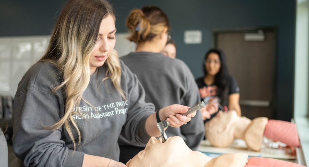 Image shows students practicing procedures on mannequins