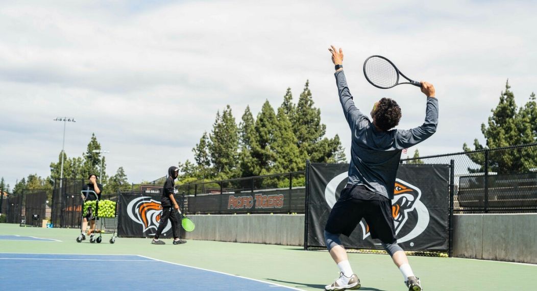 Tennis student serving