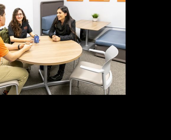 education students sitting around a table talking