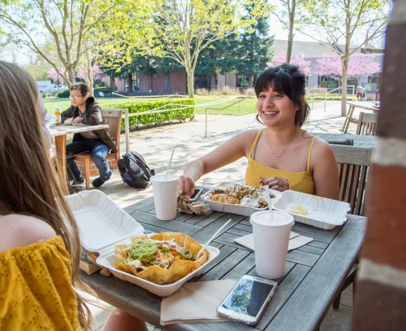 students enjoying lunch outside the DeRosa Center