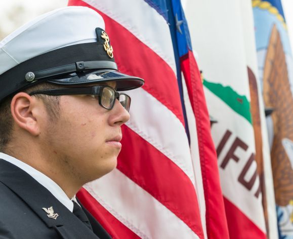 veteran student standing near flags