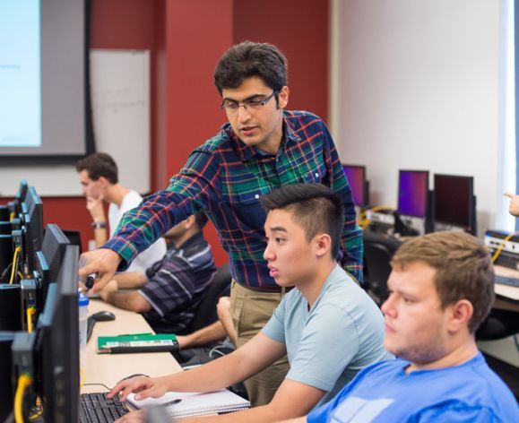 Professor teaching a student in the computer lab