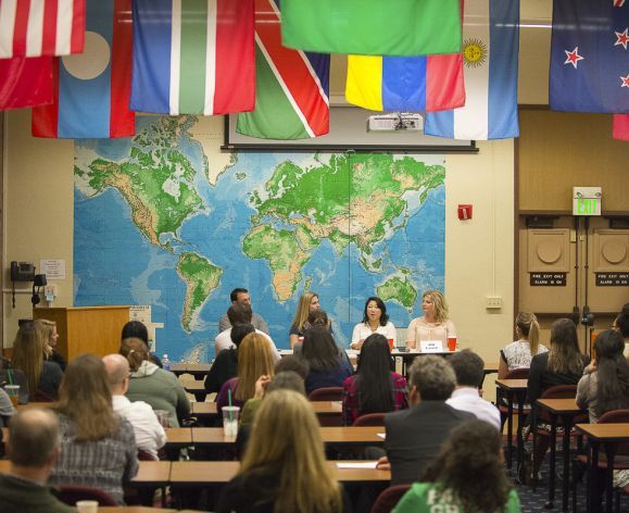 students sitting in class with flags above them