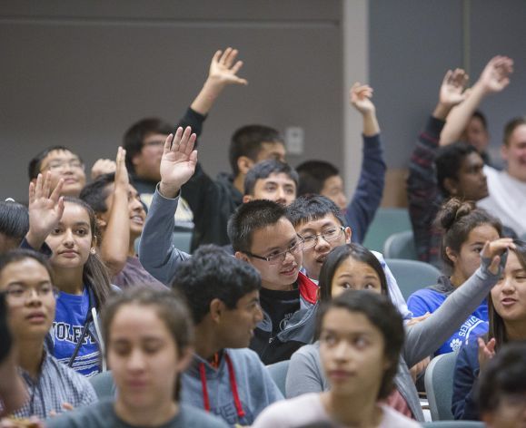 high school students raising hands