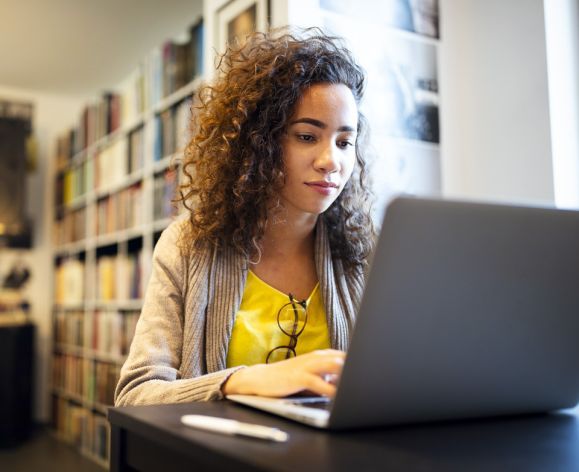 Student on a laptop researching.