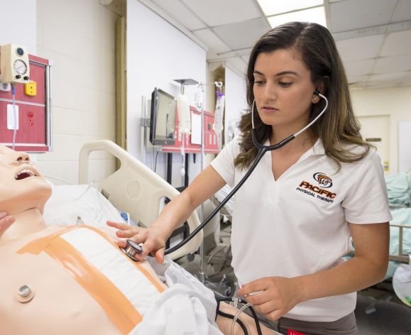 student working with healthcare dummy