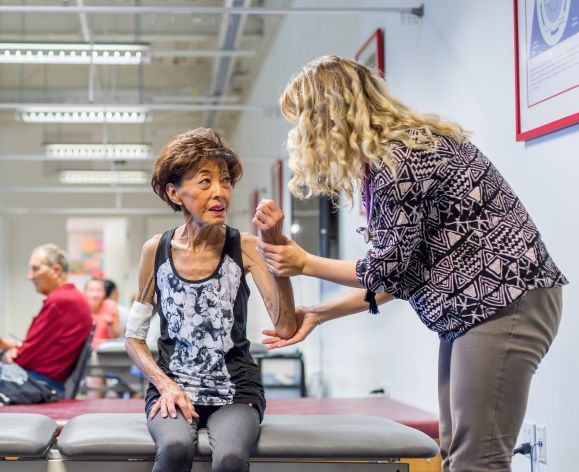 Physical therapy student working with patient