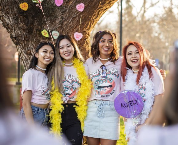 four female students wearing colorful clothes