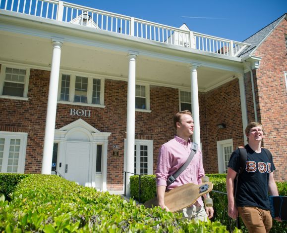 Members of Beta Theta Pi outside fraternity house